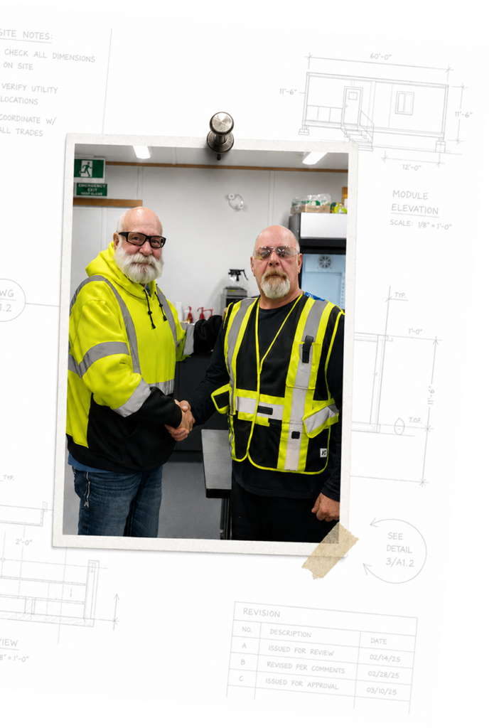 Two TA Structures team members in high-visibility workwear